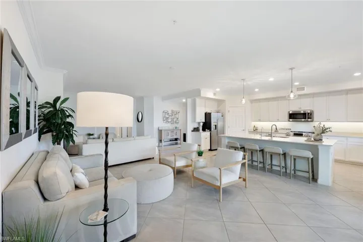 Living room with recessed lighting and light tile patterned flooring