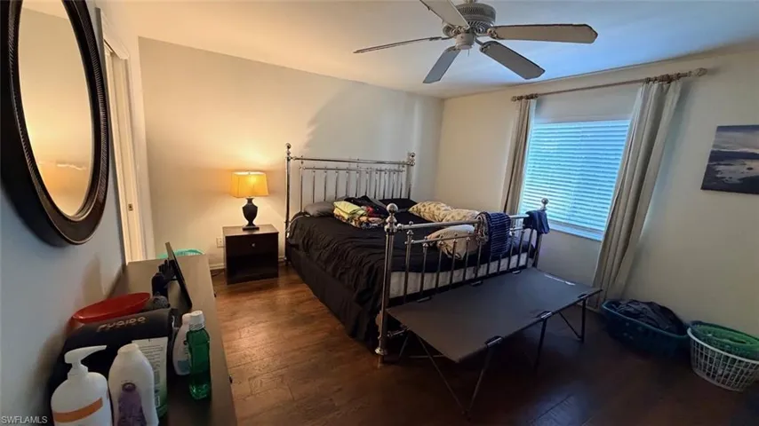 Left Unit: Bedroom featuring hardwood / wood-style flooring and ceiling fan