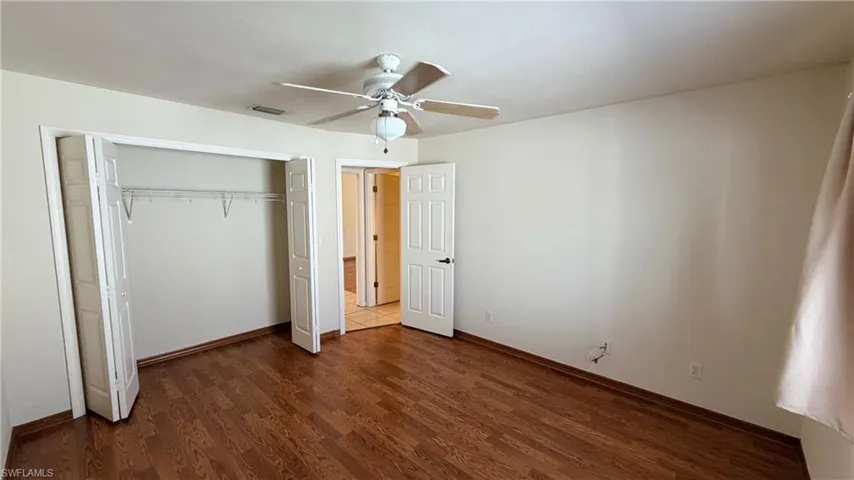 Right Unit: Guest bedroom featuring dark wood-style flooring, a closet, and a ceiling fan