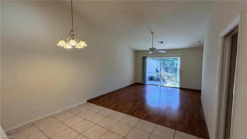 Right Unit: Unfurnished dining area with light tile patterned floors, suspended lighting, lofted ceiling, and a ceiling fan