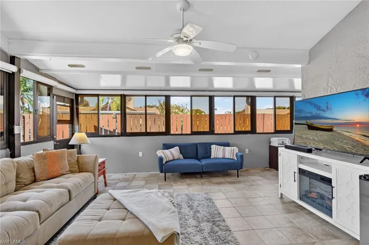 Tiled living room with a ceiling fan