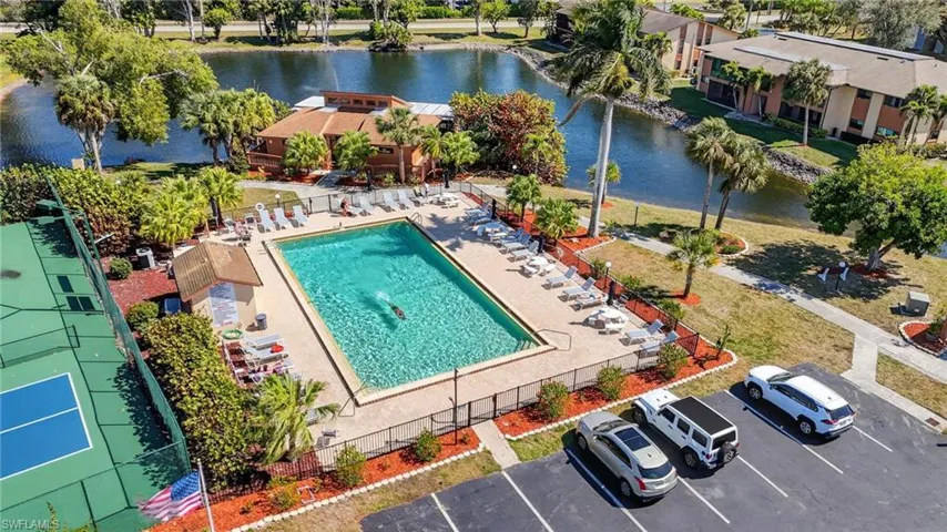 Bird's eye view of a nearby body of water and a pool area
