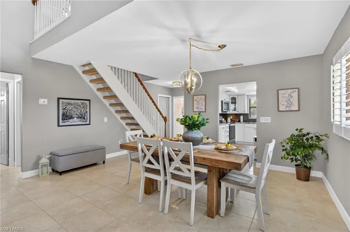 Dining area featuring hanging lights and light tile patterned flooring