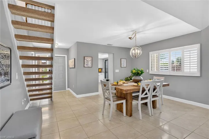Dining room featuring light tile patterned floors and hanging lights