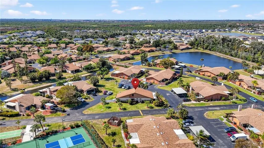 Aerial view of property's location with nearby suburban area and a large body of water