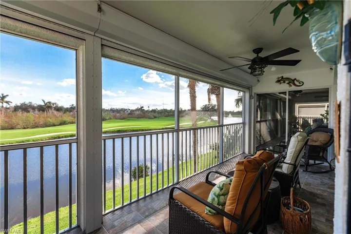 Sunroom with a water view, a wealth of natural light, and ceiling fan