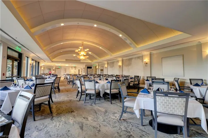 Dining area featuring lofted ceiling and an inviting chandelier
