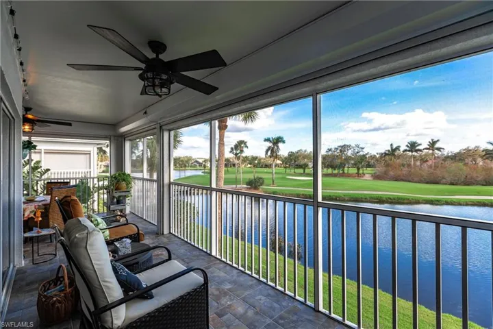 Sunroom / solarium featuring ceiling fan, a healthy amount of sunlight, and a water view