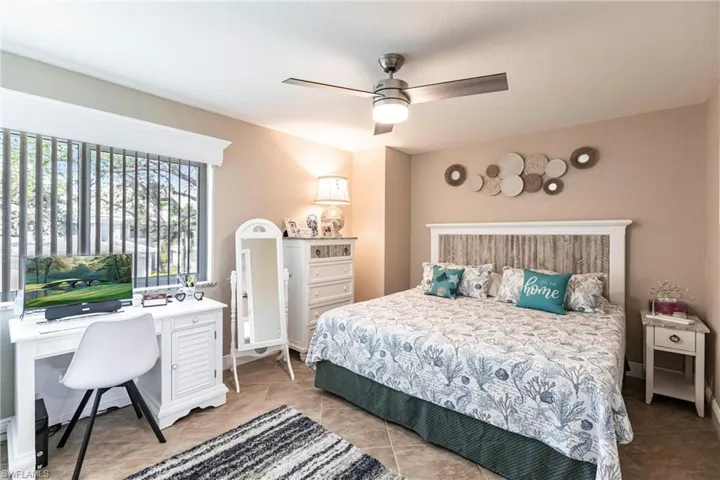 Tiled bedroom with ceiling fan