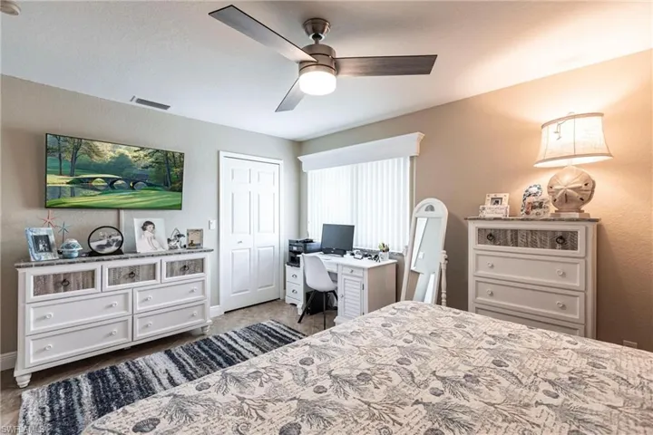 Bedroom with ceiling fan and a closet