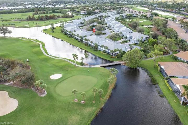 Birds eye view of property with a water view