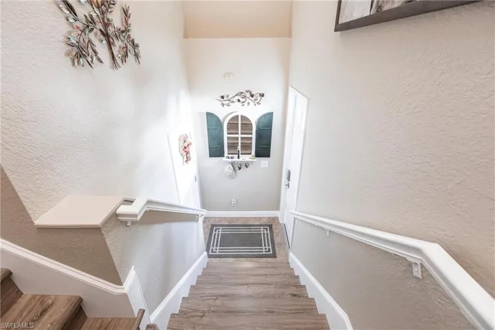 Stairway featuring hardwood / wood-style flooring