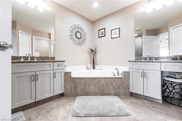 Bathroom with tiled bath and vanity