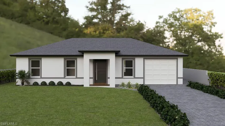 View of front of house featuring a garage and a front yard