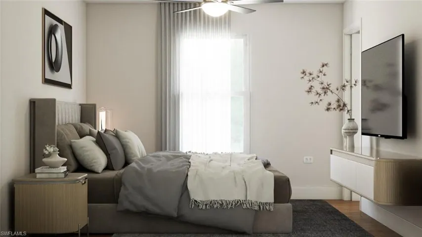 Bedroom with ceiling fan and hardwood / wood-style floors