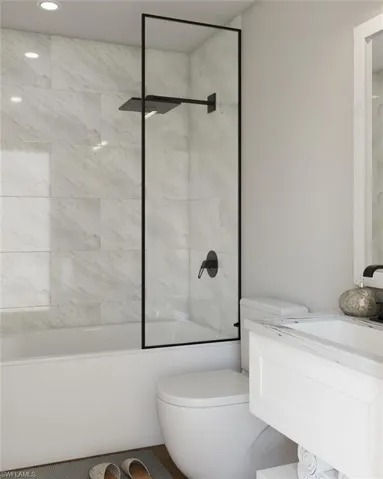 Bathroom featuring toilet and tiled shower / bath