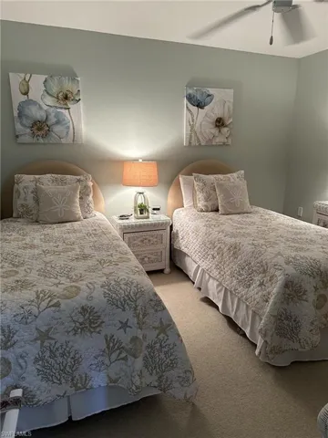 Carpeted bedroom with ceiling fan