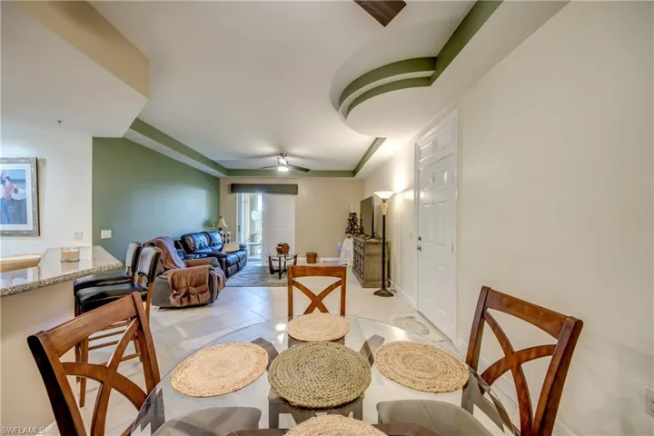 Dining area with ceiling fan and light tile patterned flooring
