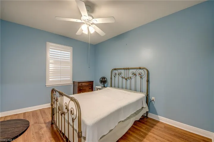 Bedroom with light wood-style floors and ceiling fan