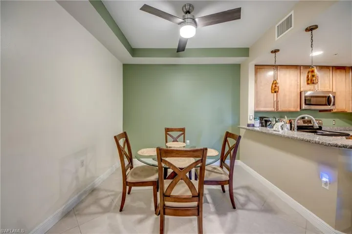 Dining space featuring a ceiling fan and light tile patterned floors