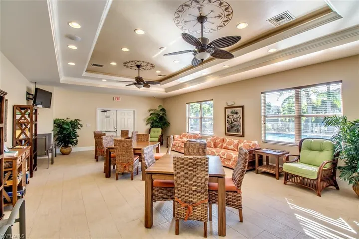 Dining room with recessed lighting, a raised ceiling, and crown molding