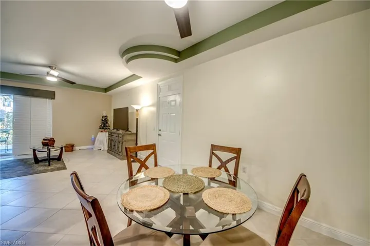 Dining space featuring a ceiling fan and light tile patterned flooring