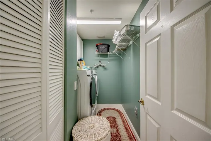 Washroom featuring baseboards and separate washer and dryer