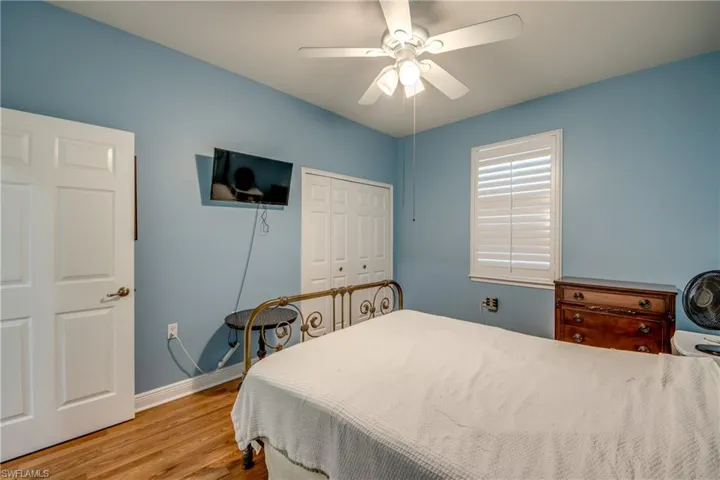 Bedroom with a ceiling fan, a closet, and wood finished floors