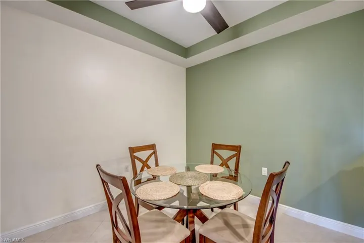 Dining area featuring light tile patterned floors and a ceiling fan