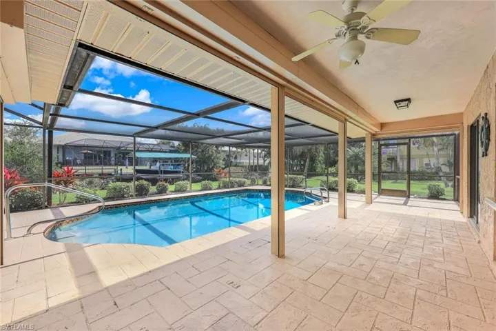 Imagine sipping your morning coffee or evening cocktails under this expansive covered lanai, with gentle breezes and peaceful canal views.