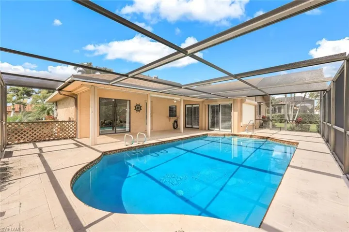 Feel the warmth of the sun as you lounge poolside in your private screened-in paradise.