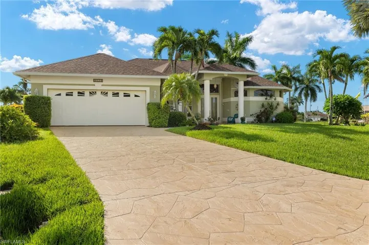 View of front of property featuring a garage and a front yard