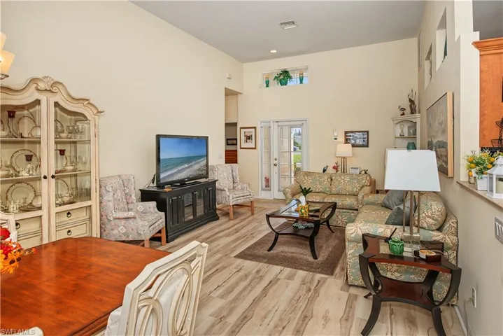 Vaulted ceilings, wood-finish flooring, and transom windows