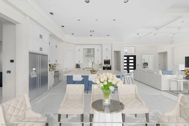 Dining area featuring coffered ceiling, crown molding, beam ceiling, and recessed lighting
