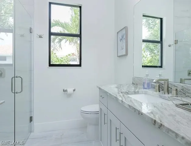 Full bathroom with a shower stall and vanity