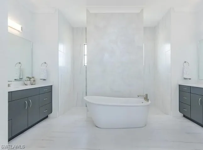 Full bath featuring vanity and a freestanding bath