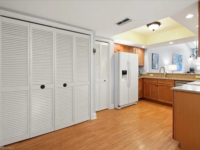 Kitchen has recessed lighting and extra storage pantry.