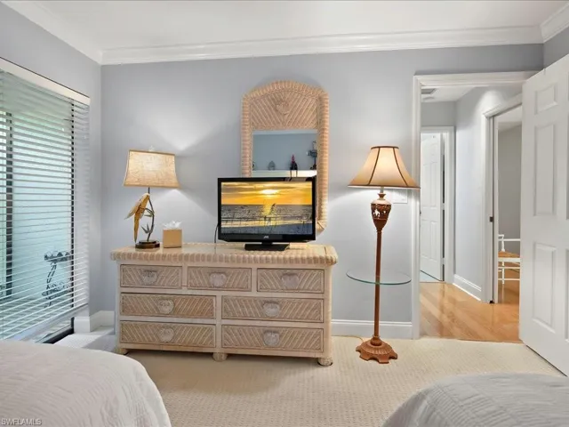 The second bedroom has sliders to a small, private lanai to the left.