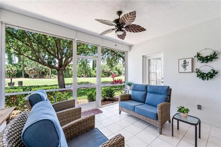 Sunroom / solarium with ceiling fan and an outdoor living space