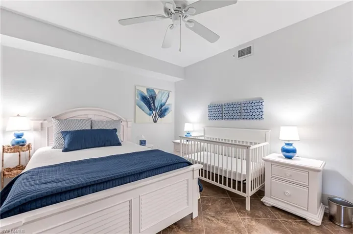 Bedroom with a ceiling fan, visible vents, and tile patterned flooring