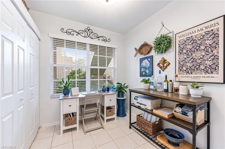 Home office with baseboards and light tile patterned floors