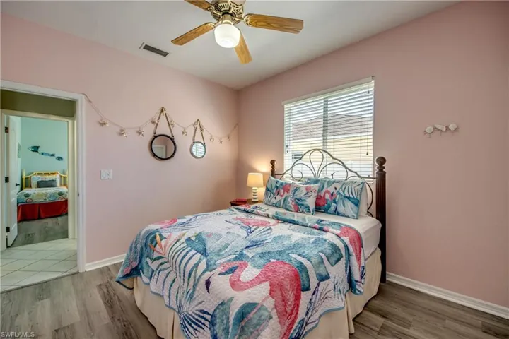 Bedroom with ceiling fan and hardwood / wood-style flooring