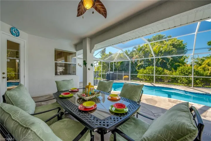 View of pool featuring ceiling fan, a lanai, and a patio