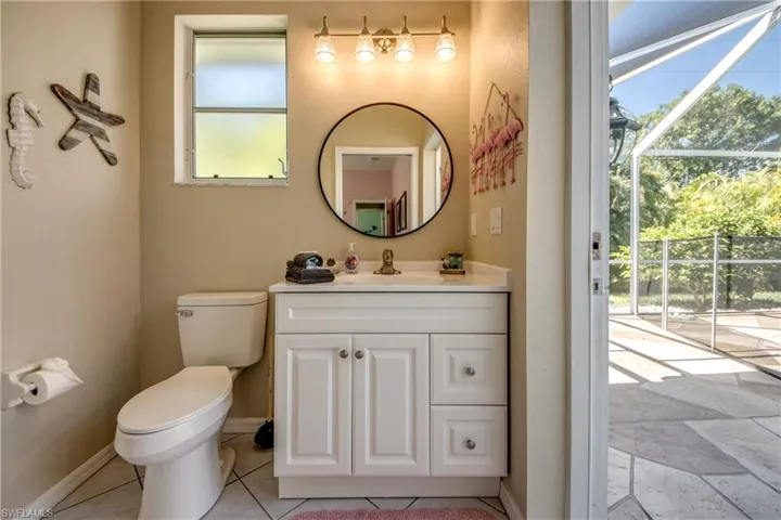 Bathroom with a wealth of natural light, toilet, and tile floors