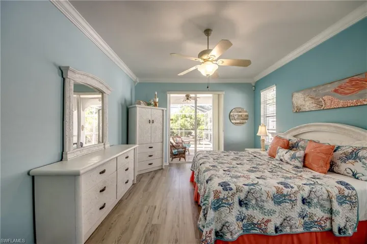 Bedroom with ceiling fan, ornamental molding, light hardwood / wood-style floors, and access to exterior