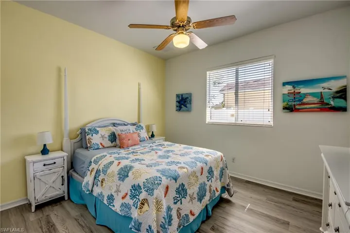 Bedroom with ceiling fan and light wood-type flooring