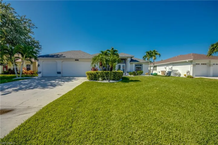 Ranch-style home with a front lawn and a garage