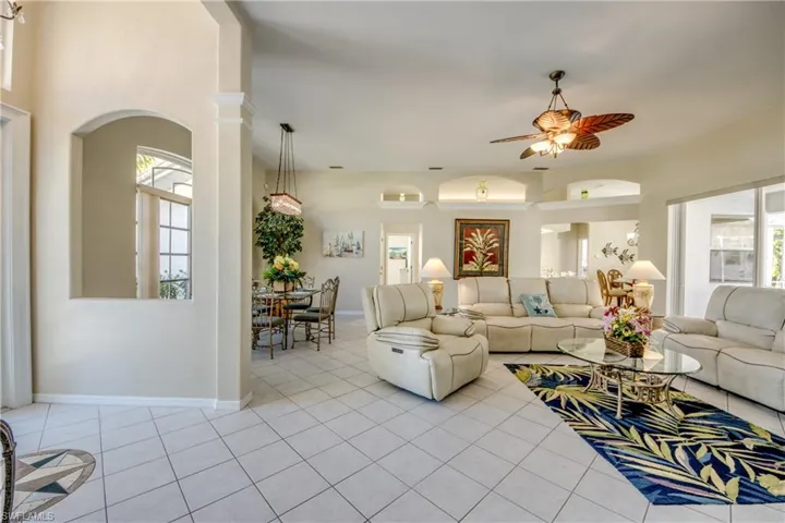 Tiled living room featuring ceiling fan