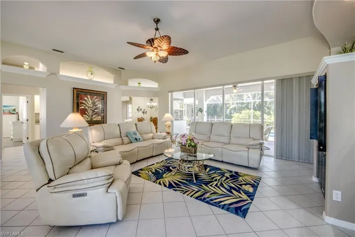Tiled living room featuring ceiling fan