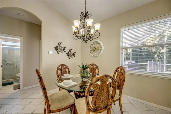 Tiled dining space with a notable chandelier
